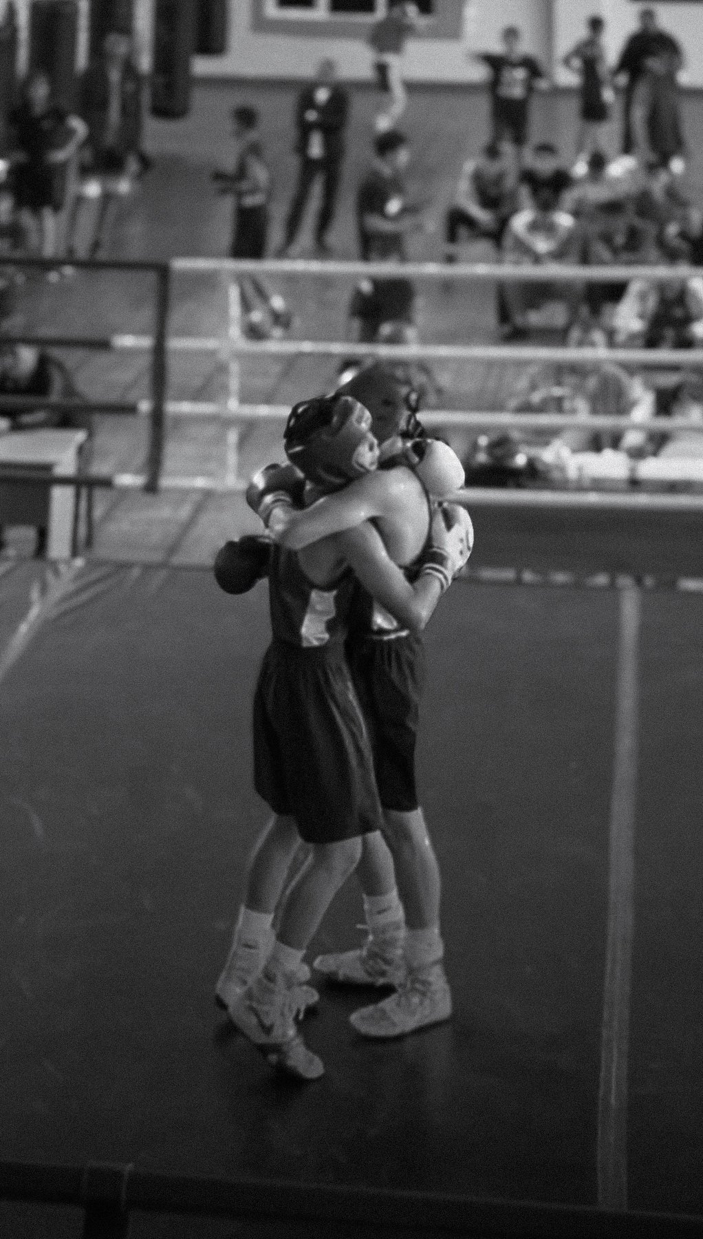 Two amateur boxers sharing a sportsmanship moment after a bout